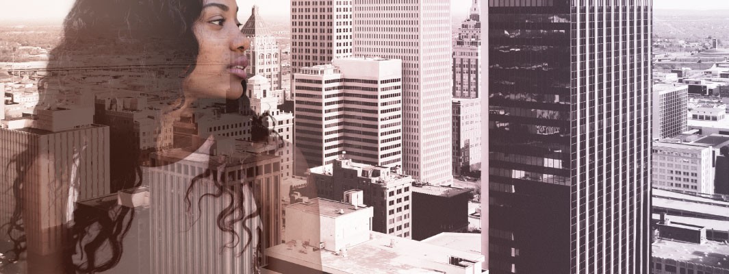 Photo of city buildings with a contemplative business woman superimposed on top.